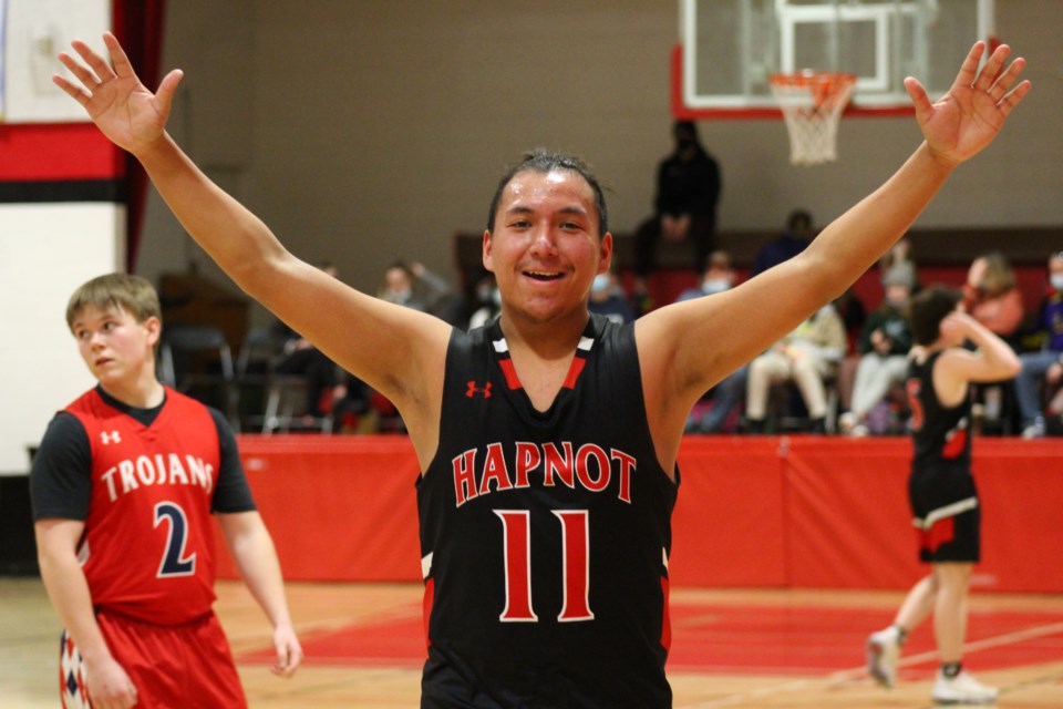 Hapnot Kopper King Kyler Colomb holds out his arms in celebration after sinking a
three-pointer.