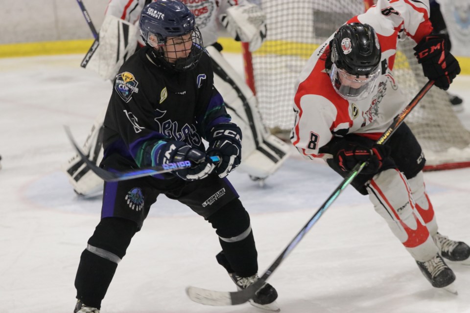 PBCN Selects forward Owen Angootealuk and Peguis Juniors defender Brodie McPherson battle for a puck during their Central Canada Cup game.