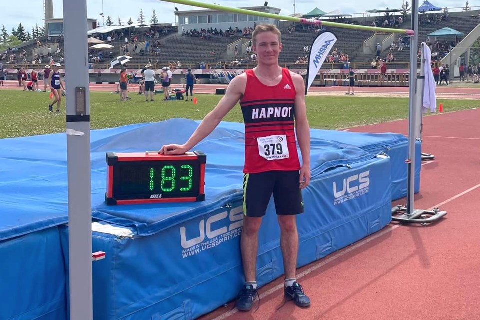 Hapnot Collegiate athlete Kenny McDonald poses with the board that shows the height of his provincial gold-medal-winning high jump. McDonald cleared a bar 1.83 metres off the ground, claiming first place in the JV high jump and picking up second in the JV pentathlon.