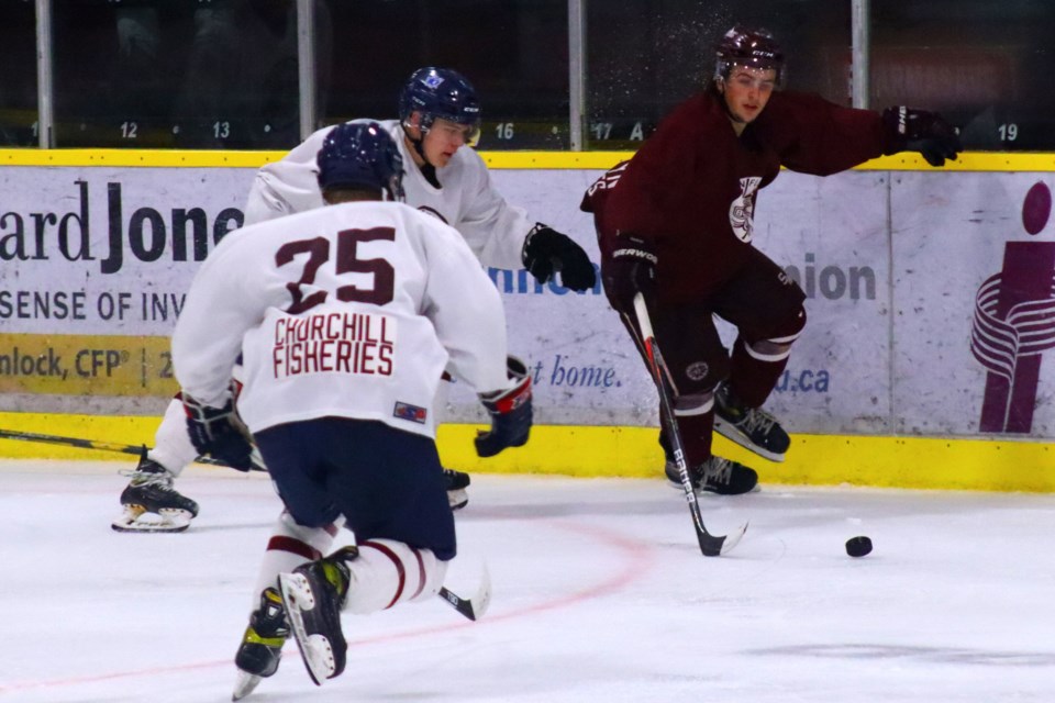 Team White's Jack Bechard and Nolan Rideout try to chase down Kylynn Olafson of Team Maroon during the Bombers' annual maroon and white game August 28.