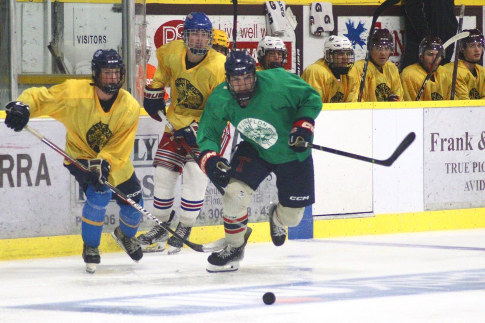 Team Yellow's Gage Gogal and David Ander and Team Green's Ryder Mucha chase after a puck during intrasquad scrimmages Sept. 1. The Bombers' camp opened Sept. 1 with a three-team intrasquad tournament for the "Jonny Doogs Cup".