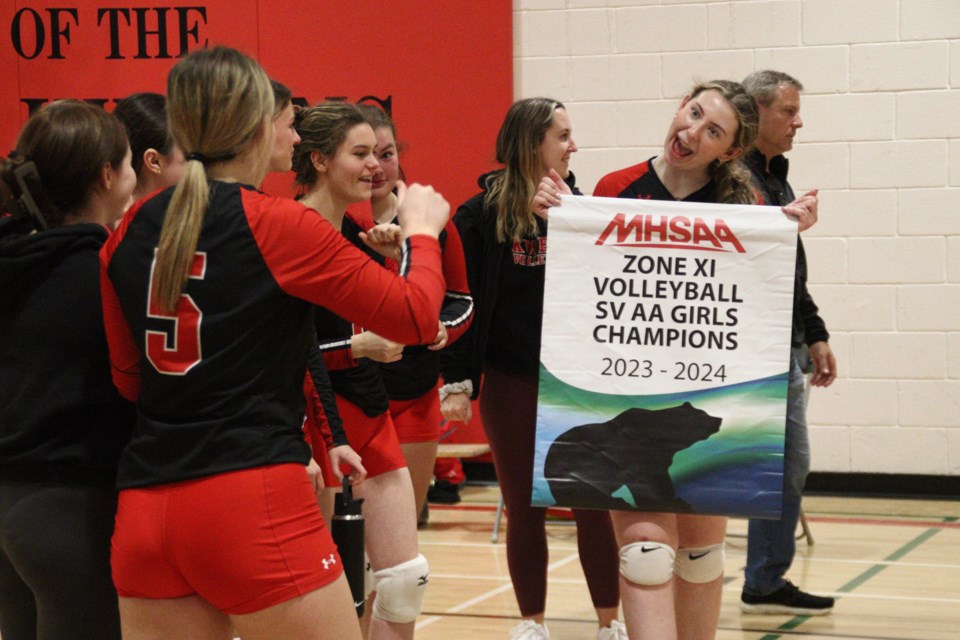 Hapnot senior Kweens players hoist their Zone 11 tournament banner for a quick photo following the team's win Nov. 18. The Kweens will advance to play provincials in Lac du Bonnet later this month.
