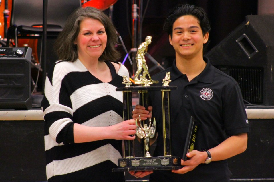 Bomber volunteer Tanya Benoit hands Gabriel Shipper the team's "Mr. Hustle" award.