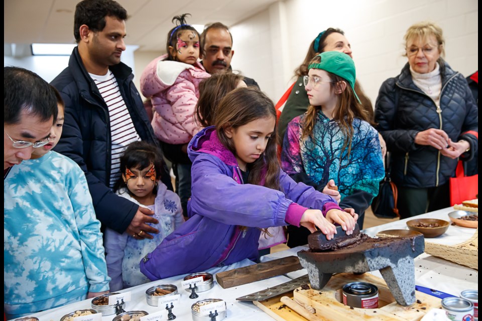 Melanie Appel tries her hand at blending the ingredients for a perfect chocolate treat at the 2023 McLean Chocolate Festival.