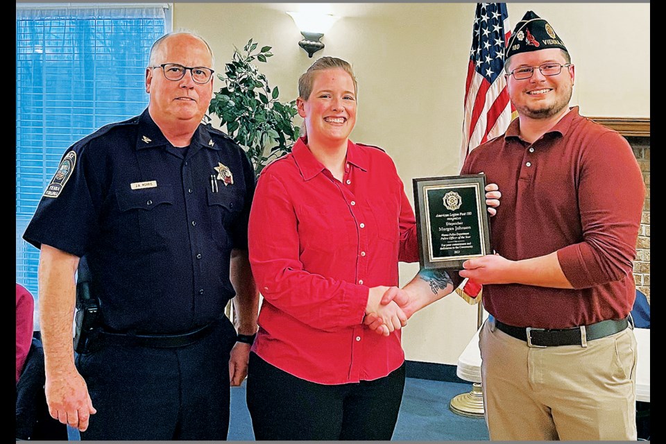Vienna police dispatcher Morgan Johnson (center) receives the American Legion Post 180’s 2023 “Vienna Police Department Police Officer of the Year” award during an April 4, 2024, ceremony at the post. Also pictured are Vienna Police Chief James Morris and the post’s commander, Tyce Williamson. 