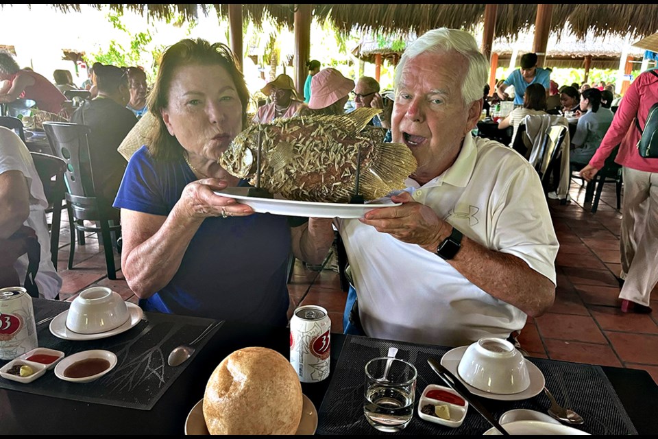 Linda Chandler and Pat Keough have some fun as they prepare to enjoy a sumptuous meal during the Arlington Chamber of Commerce's November 2023 journey to Vietnam.