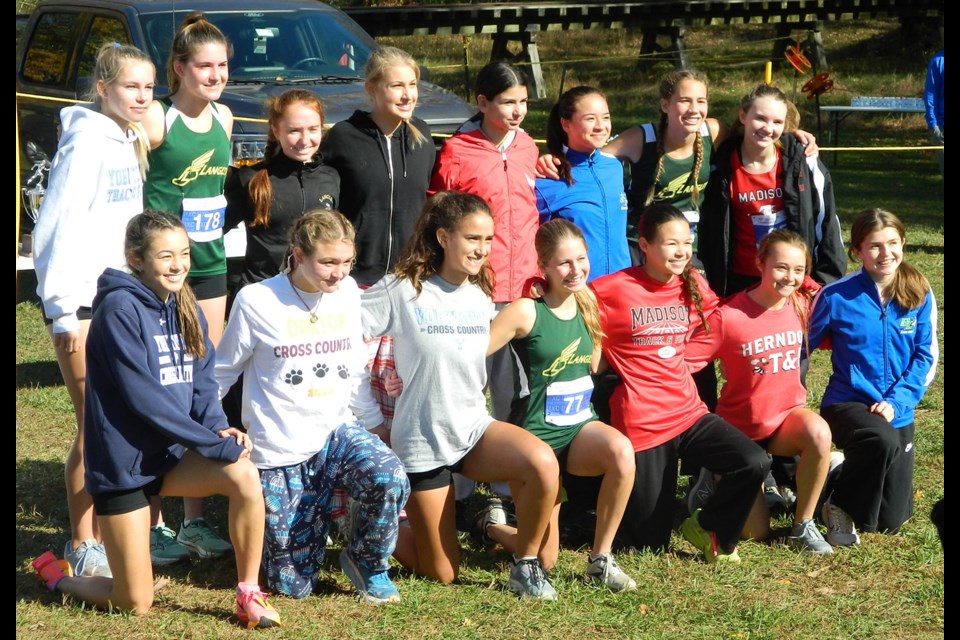 The top 15 runners at the girls 6D North Region cross country championships gather for a photo. Caroline Elliott of South Lakes, far right front row, finished first.