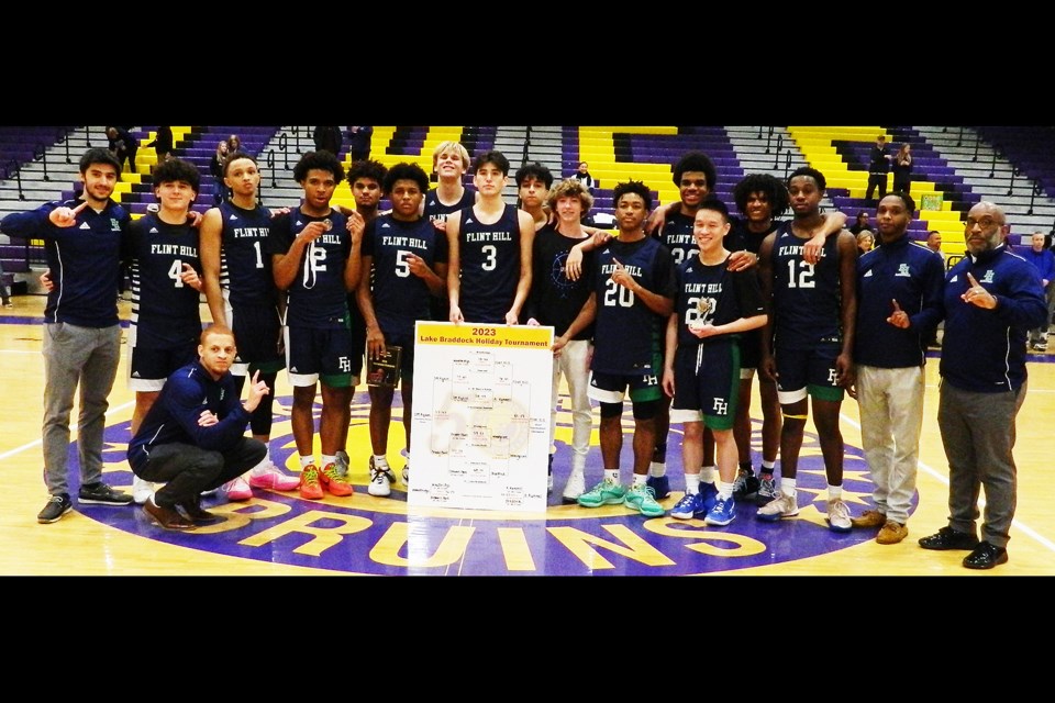 The Flint Hill Huskies gather after winning the holiday tournament at Lake Braddock Secondary School.