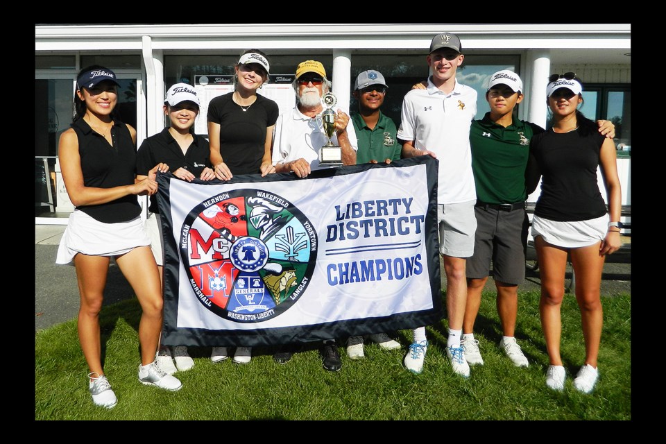 The Langley Saxons gather with the 2023 Liberty District golf tournament championship banner.