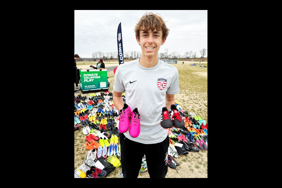 Lawson Watt holds some shoes that were donated.