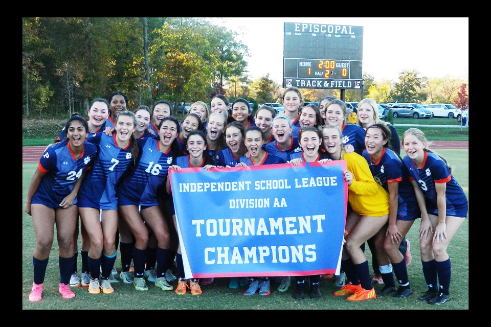 The Potomac School Panthers gather behind the championship banner after winning the Independent School League's AA girls soccer tournament.