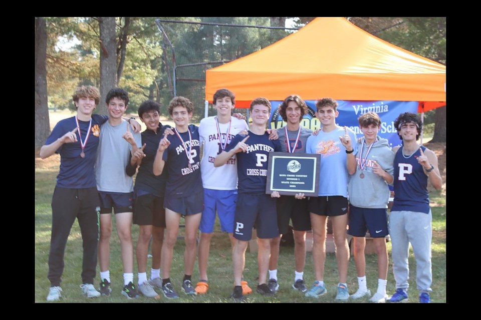 The Potomac School boys cross country team gathers with the plaque and their medals for winning the Division I private-school state championship.