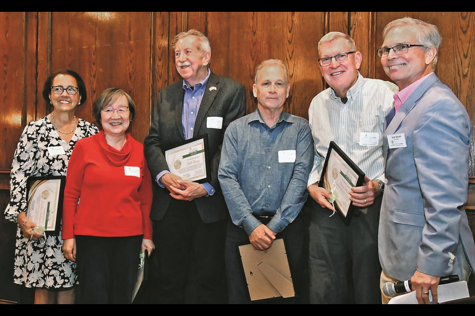 Pauline Solomita, Jill Miller, Jack Roney, Patrick Tansey and Doug White accept Service Pin awards from W. Scott Schroth, board chairman of the Shepherd's Center of Northern Virginia, during an April 25, 2024, luncheon in Tysons. 
