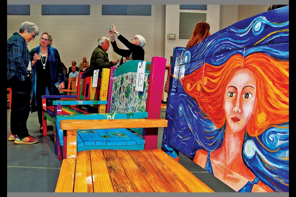 Colorfully painted benches, including "Sky Vibes" (right) by Lula Sandra Gover, went to the highest bidder Nov. 11, 2023, during the Vienna Arts Society's "Take a Seat Vienna" fund-raising auction at the Vienna Community Center. 