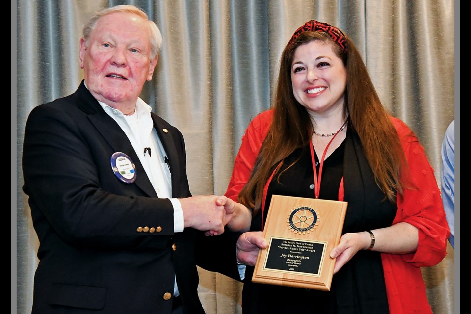 Vienna Parks and Recreation Department employee Joy Harrington accepts a Rotarian M. Jane Seeman "Service Above Self" Award from Rotary Club of Vienna member George Creed during an April 17, 2024, luncheon at Westwood Country Club. 
