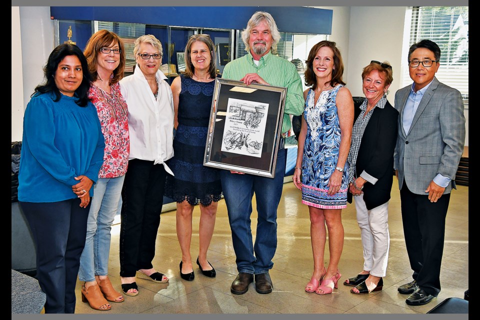 Tim Fricker, owner of Bikes@Vienna, receives the Carole Wolfand Community Service Award from the Town Business Liaison Committee and Mayor Linda Colbert during the Volunteer Recognition Day ceremony April 18, 2023, at the Vienna Volunteer Fire Department. 