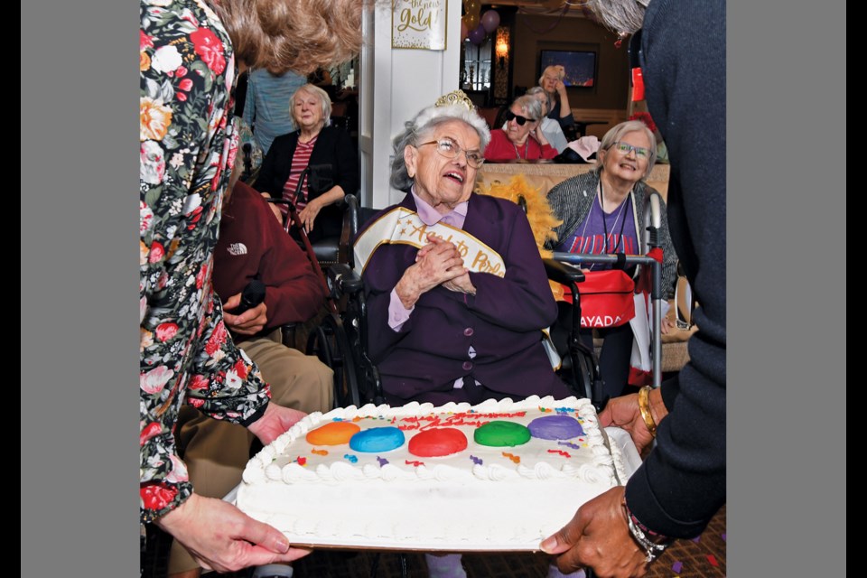 Porta Nickles, long known for her smile and positive attitude, beams as staff members at Brightview Senior Living in Great Falls present her with a cake Feb. 15, 2023, on her 107th birthday.
