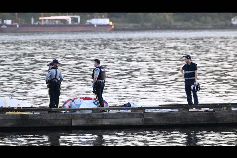BC Coroner Service and RCMP stand near a tube after two boats collided on June 7 2025. 