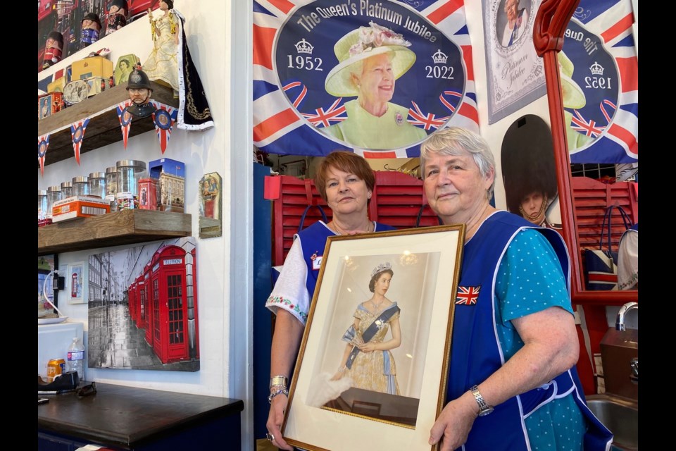 The British Home’s owner Lenny Entwistle, left, and store clerk Elly Fenton often welcome customers wishing to speak about Queen Elizabeth II. Upon her death they expect more conversations about the Queen's life.