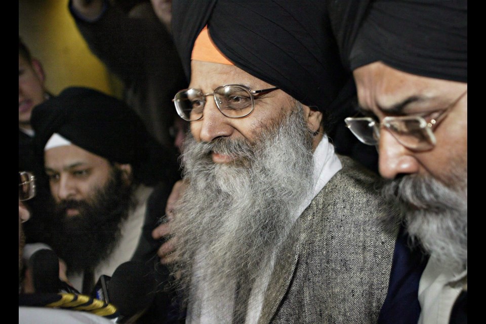 Ripudaman Singh Malik (centre) leaves B.C. Supreme Court in Vancouver in this 2005 file photo after he was found not guilty in the bombing of an Air India flight 182 in 1985.