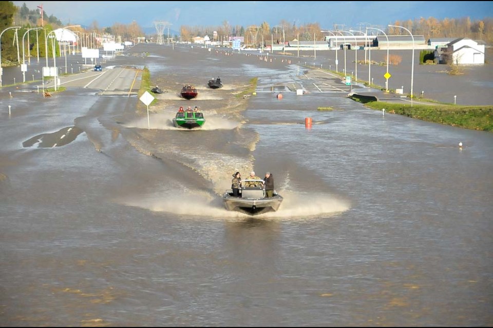 Jet boats ply the waters of a flooded Trans-Canada Highway in Abbotsford, B.C., on Nov. 15, 2021. A new study has found the flooding that hit the province was made two to four times as likely due to human influence on the global climate system. - STEFAN LABBÉ/GLACIER MEDIA