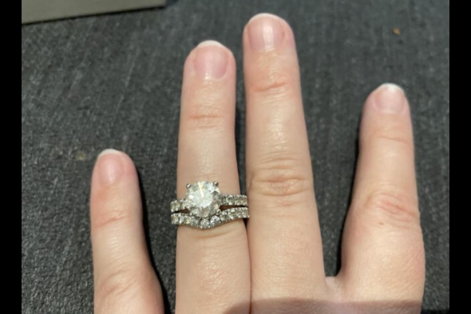 Aja Thew's engagement ring and wedding band pictured on her finger before resizing was completed.