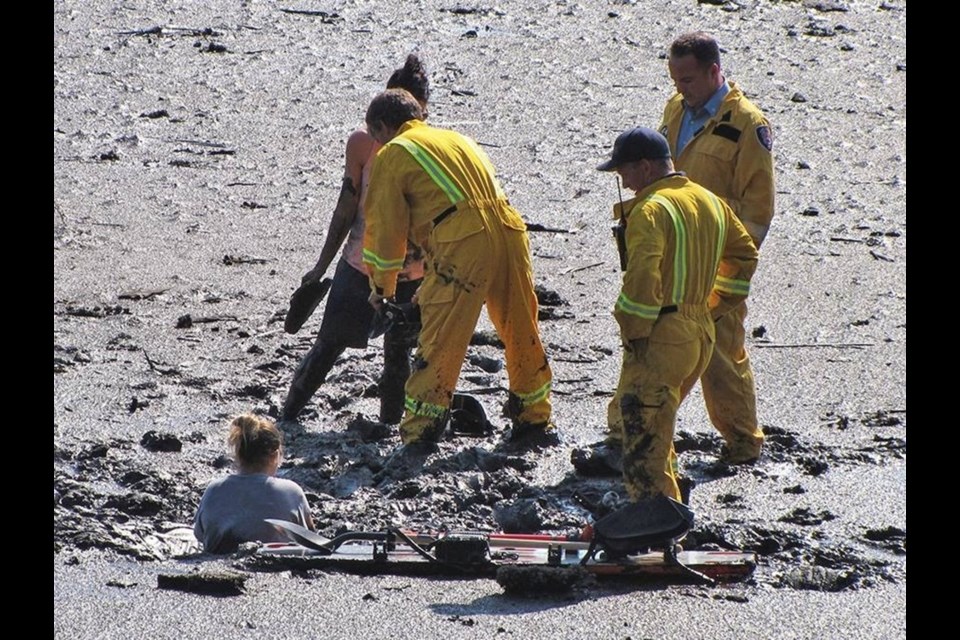 A photograph taken of a person sinking and trapped in the mud flats from a few years ago. Firefighters in Port Moody responded to a call just two weeks ago for a similar situation.