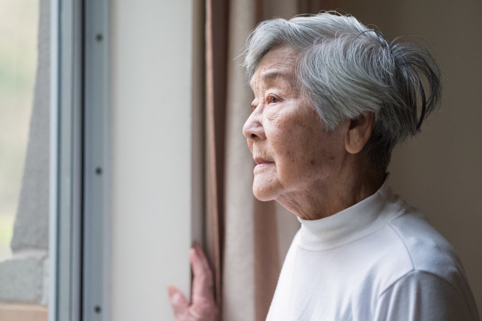 ElderlyAsianladylookingoutwindow