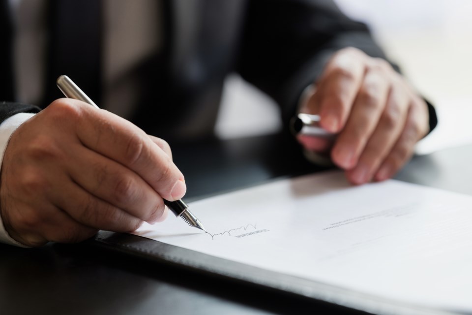 lawyer signs paperwork