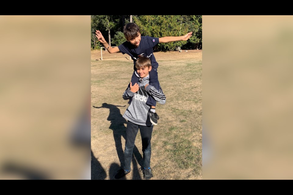 Matthew with his brother Alex Lowenberger on his shoulders as he did the other day to avoid the bear.