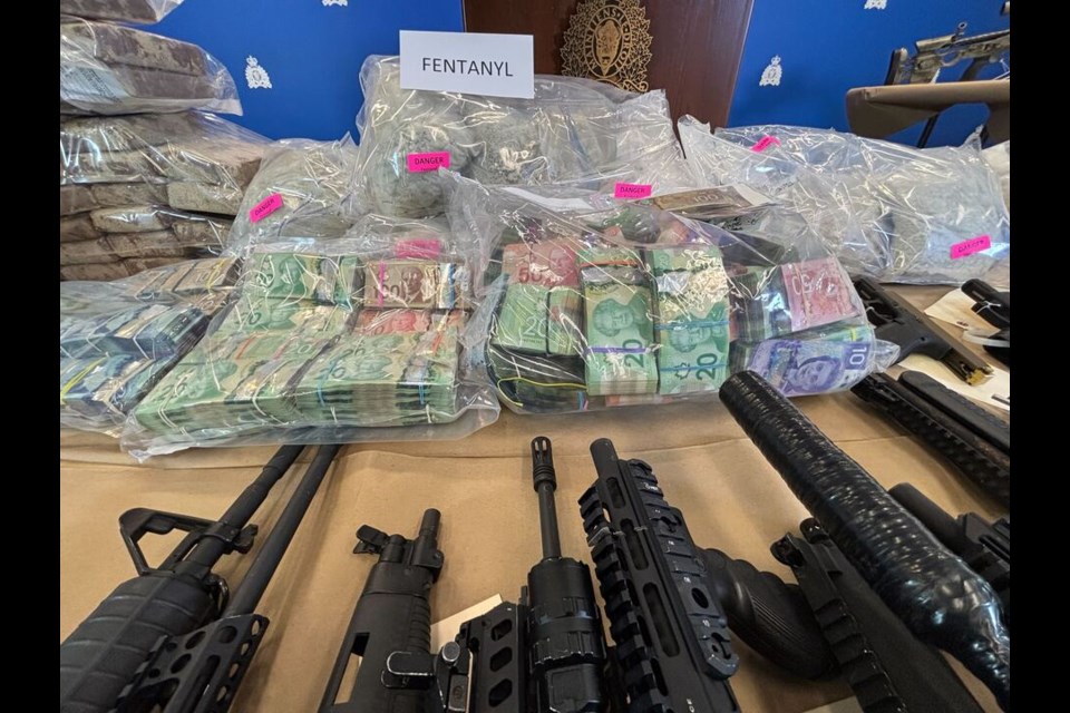 RCMP investigators show off seized weapons, drugs, cash and firearms from what they say is the 'largest, most sophisticated drug superlab in Canada.’ 