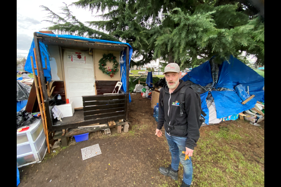 Roy Runions, seen here Jan. 31, 2024, has been living in a tiny home structure near the Oak Street Bridge for over a year.