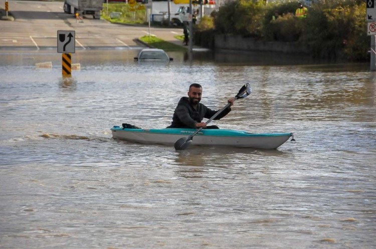 A man crosses a flooded section of road near the Trans-Canada Highway in Sumas Prairie, B.C., Nov. 15, 2021. - Stefan Labbé/Glacier Media