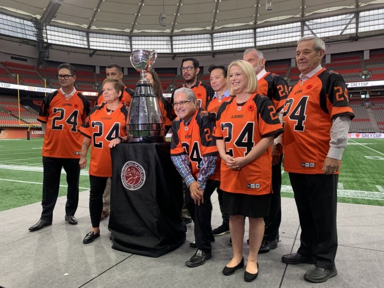 Officials, including B.C. tourism minister Lisa Beare, Vancouver mayor-elect Ken Sim, BC Lions president/CEO Rich LeLacheur and club COO Duane Vienneau, at Thursday's Grey Cup announcement at BC Place.