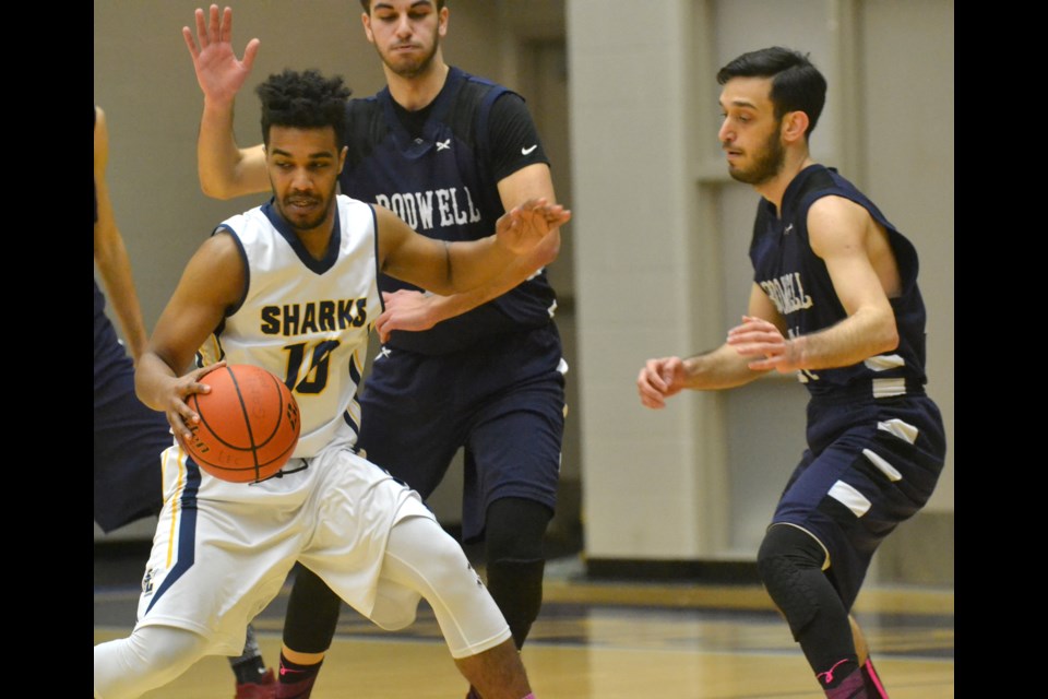 Steveston-London's Isaiah Hunter works against a pair of Bodwell opponents during Thursday night's 68-61 quarter-final loss at the B.C. 3A Boys Basketball Championships in Langley.