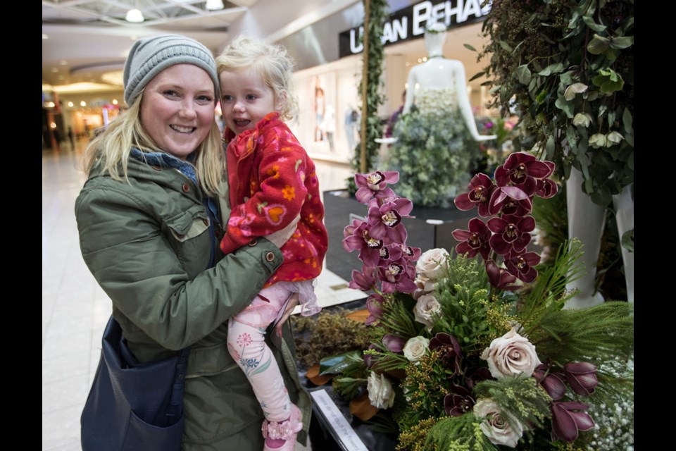 Kim Spears and three-year-old daughter Marina Spears check out the Fleurs de Villes floral mannequin series at Mayfair Shopping Centre.