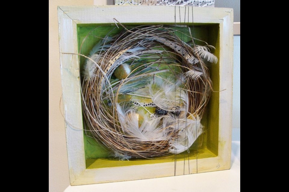 Nancy Slaght, a construction of wooden box, thread, acrylic paint, natural fibres, feathers, felt and musical score.