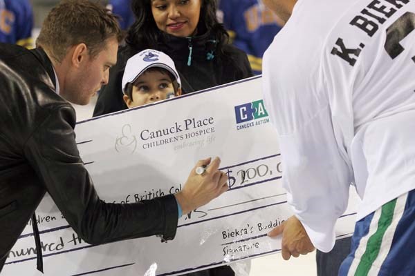 Michael Buble makes a $100,000 donation and doubles the $100,000 raised for the three charities benefiting from the game between NHL professionals and the UBC men's hockey team Oct. 17 at Thunderbird Sports Centre.