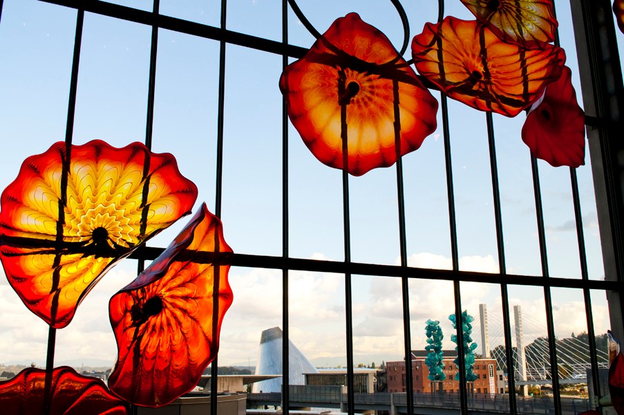 Looking through a glass art installation at Union Station, visitors can see Museum of Glass and Chihuly Bridge of Glass.