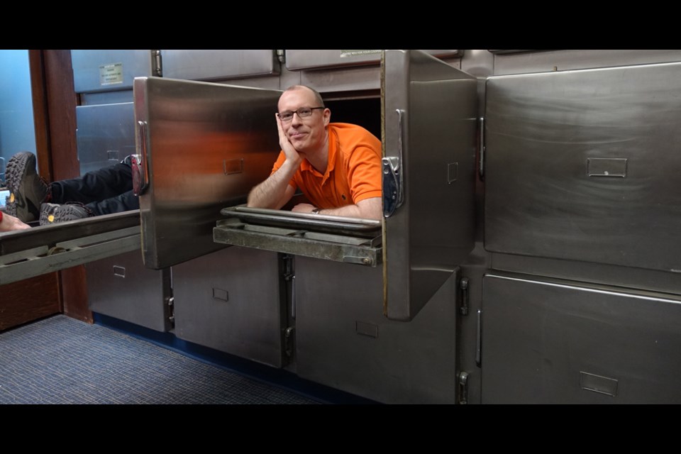 Paul Kingsbury, a geography professor at Simon Fraser University, has some fun at the morgue at the Vancouver Police Museum.