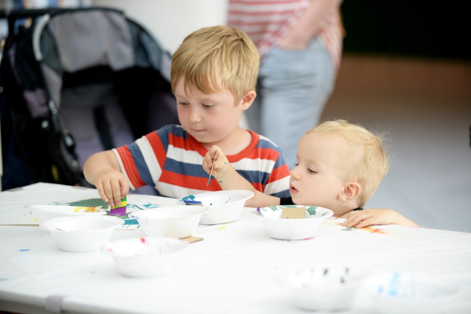 Zakir Dolinski, 4, and Elijah Dolinski, 1 try their hand at painting during an ArtsToGo workshop in June 2016. Another free art workshop is coming up at Royal City Centre on Sunday, April 2.