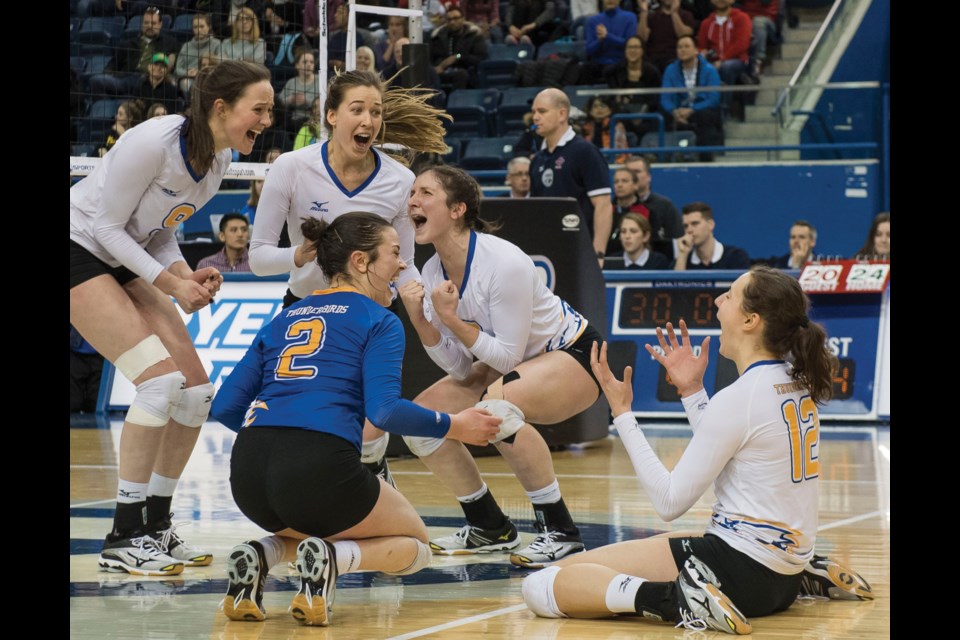 An elated Juliana Kaufmanis (second from top left) celebrates match point with her UBC teammates after a four-set victory over Alberta in last weekend’s gold medal match at the national championships in Toronto. It was the final time on the floor in the McMath graduate’s university volleyball