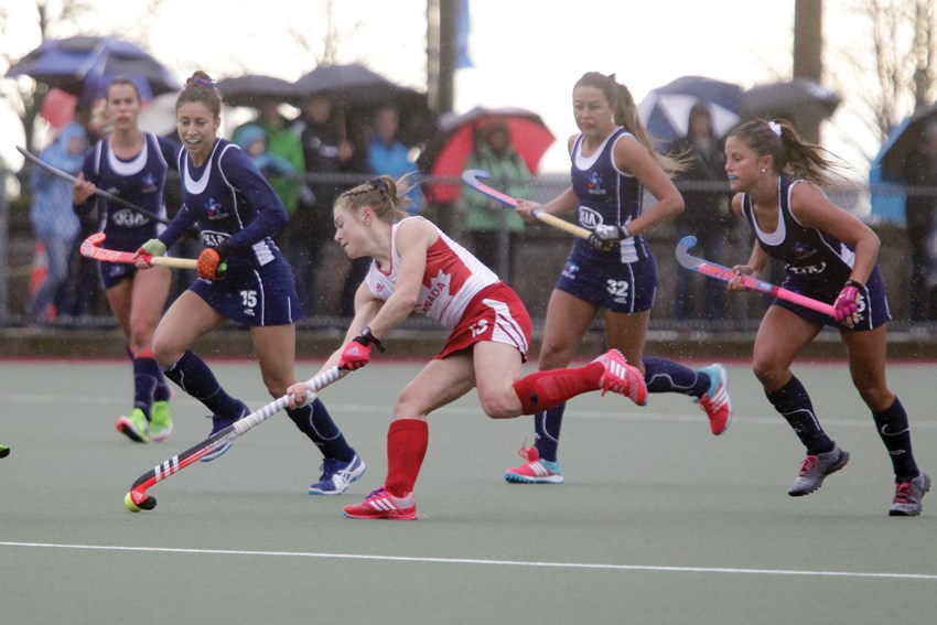 North Vancouver’s Hannah Haughn dances through defenders during a 3-1 win for Canada over Chile in an international field hockey matchup Wednesday at West Vancouver’s Rutledge Field. Haughn will be one of five North Shore players suiting up for Canada during a World League event running April 1-9 at Rutledge. photos Kevin Hill, North Shore News