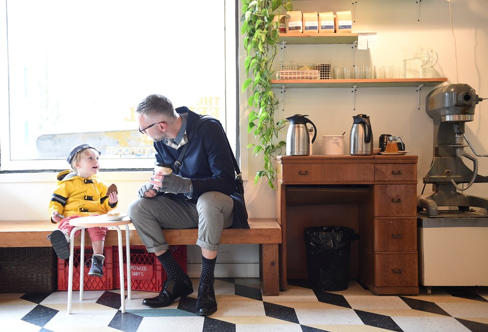 Simon Woodcock and his son, Luka, enjoy a cookie and coffee at the recently opened Federal Store in