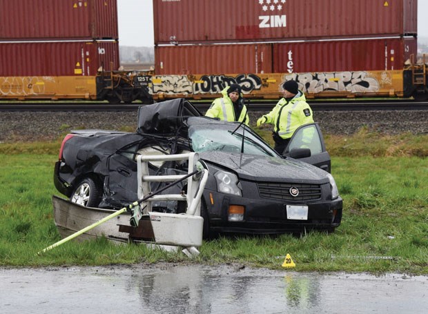 Delta police officers investigate a two-vehicle collision on Deltaport Way Wednesday morning that claimed the life of a 40-year-old Surrey man.