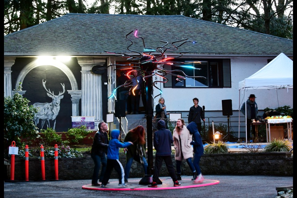 Visitors check out Robert Turriff’s Pulse Quasar at Deer Lake Gallery. It’s part of the Luminescence II exhibition, where a special closing gala is set for Friday, April 7.