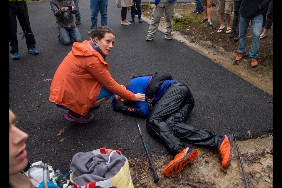 Gary Robbins collapses in exhaustion with his wife Linda Barton-Robbins by his side following 2½ days of racing. photo Michael Doyle/Canadian Running Magazine