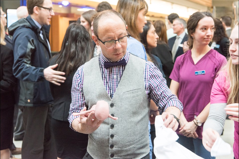 BCIT School of Health Sciences faculty member Rob Kruger handles a 25-week-premature simulation robot baby during an funding announcement about the institute's new Health Sciences Centre for Advanced Simulation last Wednesday.