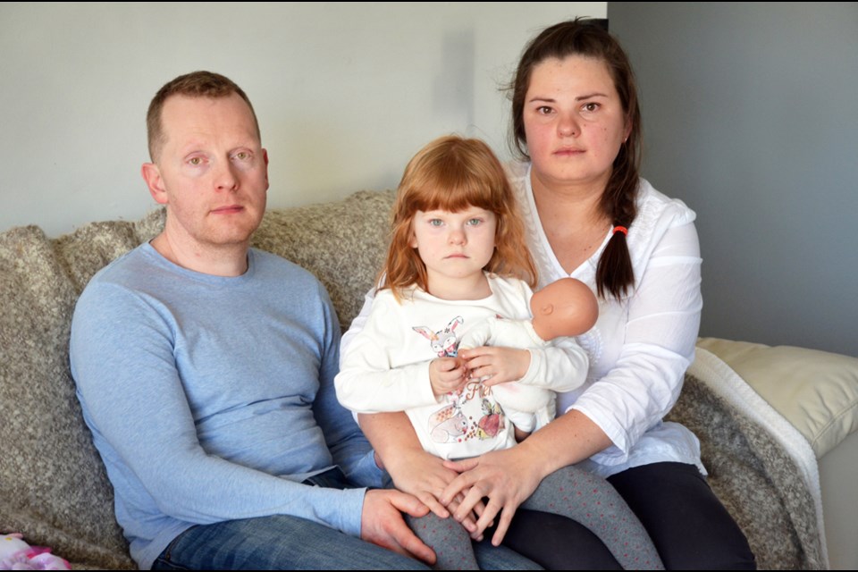 Oleh Chentsov, left, with his three-year-old daugther Alevtina and wife, Irina Levinova. The family has lived at Claremont Terrace for the last three years and was given an eviction notice last week. The landlord wants to renovate the suite, but the family says that’s just an excuse to kick them out and increase the rent.