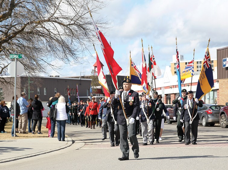 Members of the Royal Canadian Legion Branch 43 colour guard lead the parade procession to the cenotaph in front of city hall Sunday to commemorate the 100th anniversary of the Battle of Vimy Ridge.